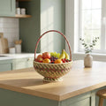 Fruit basket on a kitchen counter with a window in the background