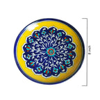Decorative plate with blue floral design on a yellow background, size indicated as 8 inches.