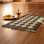 Checkered mat on a wooden floor with decorative items including flowers and a lamp.