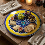 Decorative plate with assorted appetizers on a wooden table with wine and cutlery.