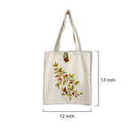 Beige tote bag with leaf design and measurements on a white background
