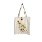 Beige tote bag with leaf design on a white background