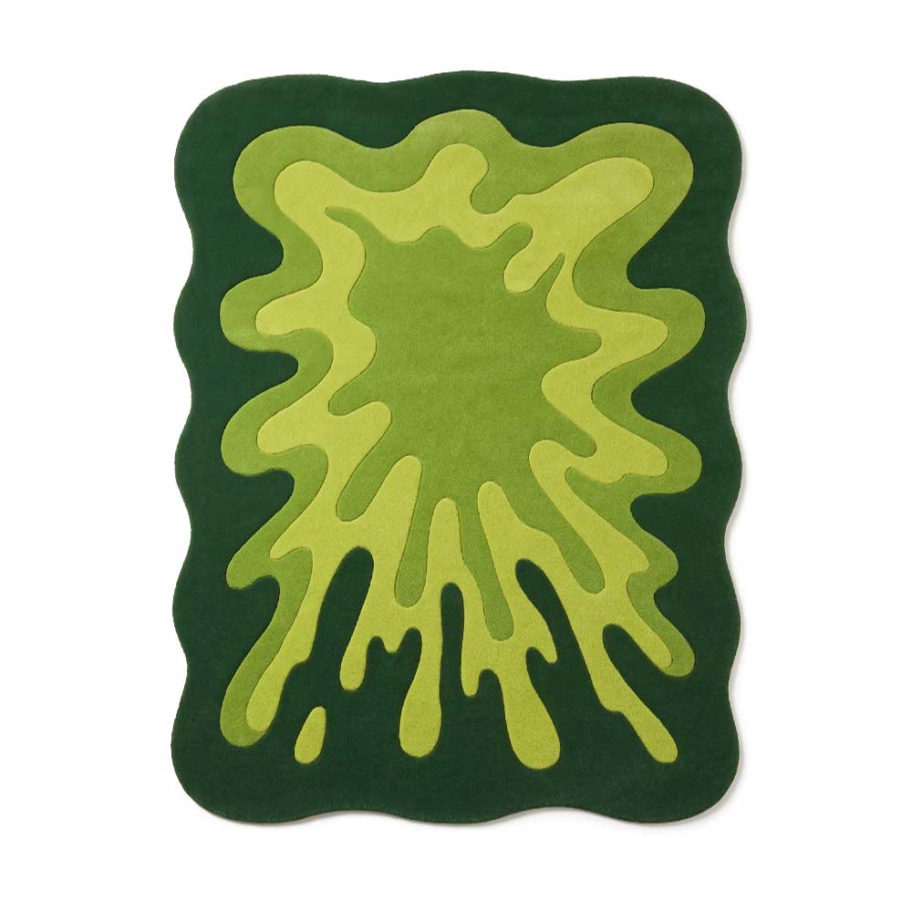 Top-down view of a vibrant green abstract splatter shape New Zealand wool rug.