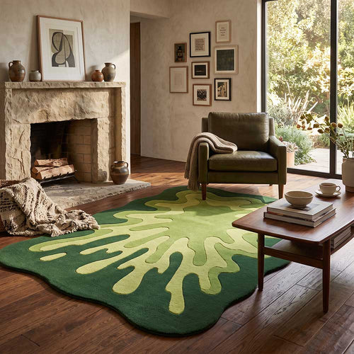 Angled view of the organic-shaped green rug in a bright modern living space.