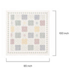 Detailed close-up of geometric applique embroidery on artisan cotton bedspread