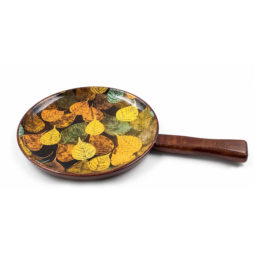 Close-up view of the handcrafted mango wood handle and enamel leaf print detail on a luxury serving tray.