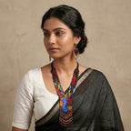 Side angle view of the multi-colored fringe on the beaded peacock necklace