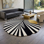 Top-down view of the Bhadohi-crafted artisan rug highlighting its unique asymmetric shape and color contrast.