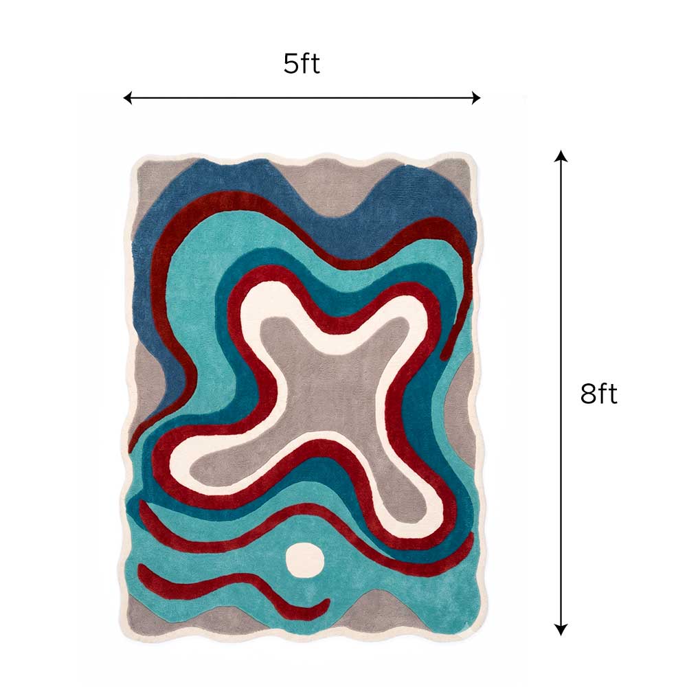 Close-up detail of the hand-tufted wool texture and color transition on the abstract designer rug.