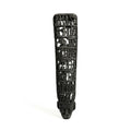 Black decorative item with intricate carvings on a white background