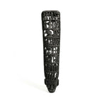 Black decorative item with intricate carvings on a white background