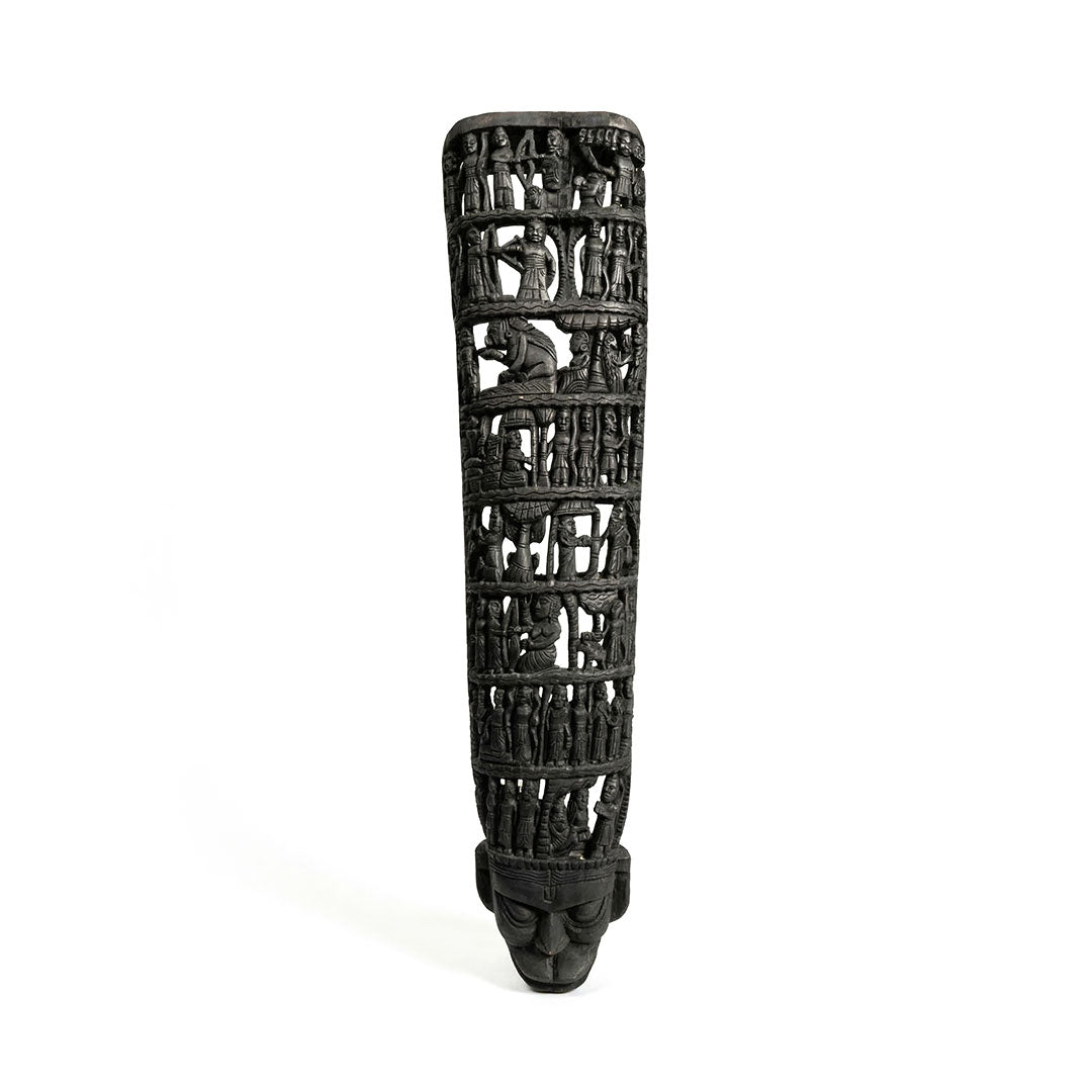 Black decorative item with intricate carvings on a white background