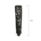 Decorative black sculpture with skull design on a white background