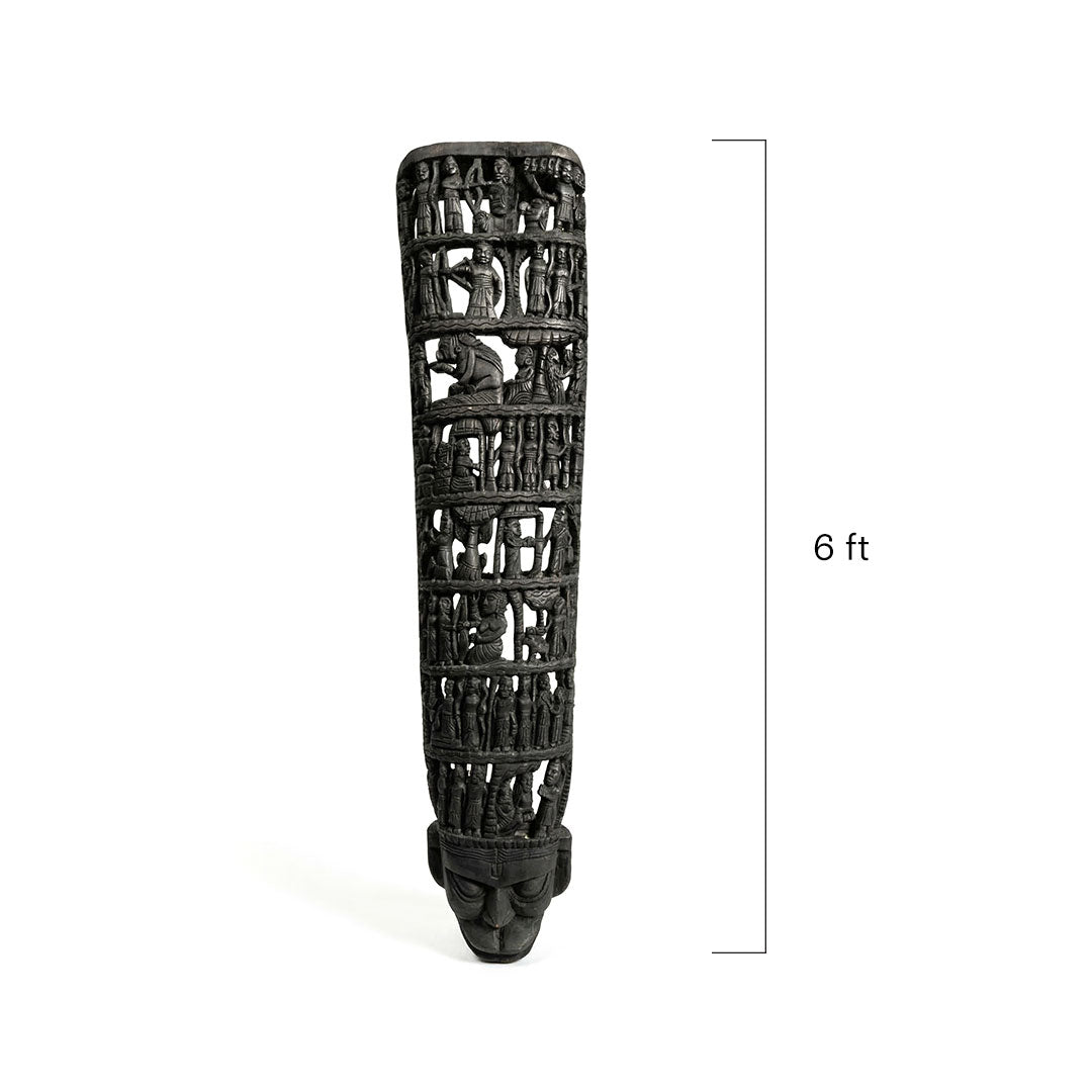 Decorative black sculpture with skull design on a white background