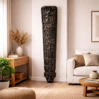 Decorative wall piece in a living room setting with a couch and coffee table.