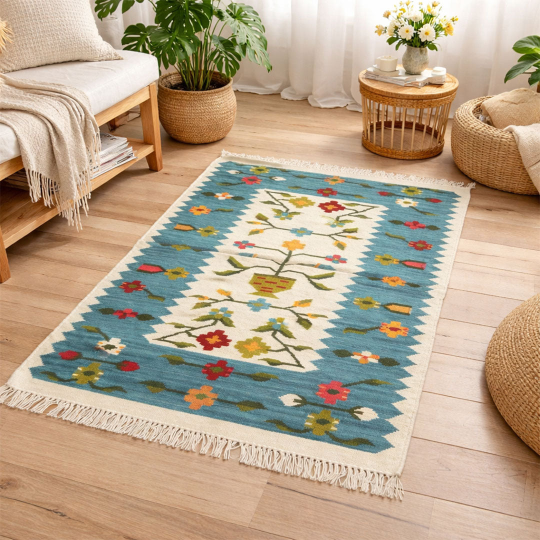 Decorative rug with floral pattern on a wooden floor in a living room setting.