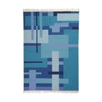 Blue geometric patterned rug on a white background