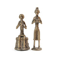 Two bronze statues of figures on a white background