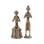 Two bronze statues of figures on a white background