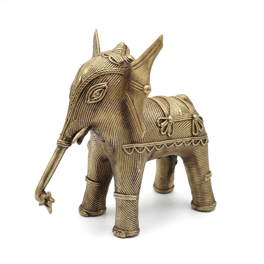 Decorative brass elephant figure on a white background