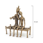Bronze statue of two figures on a bench with a measurement label indicating 5 inches.