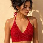 Flat lay of bright purple crochet bikini top.