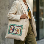 Person wearing a beige blazer with a tote bag featuring a colorful design.