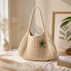 Stylized view of the cream crochet tote bag showing interior space and handle construction.