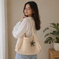Side profile showing the depth and weave construction of the cream crochet tote bag.