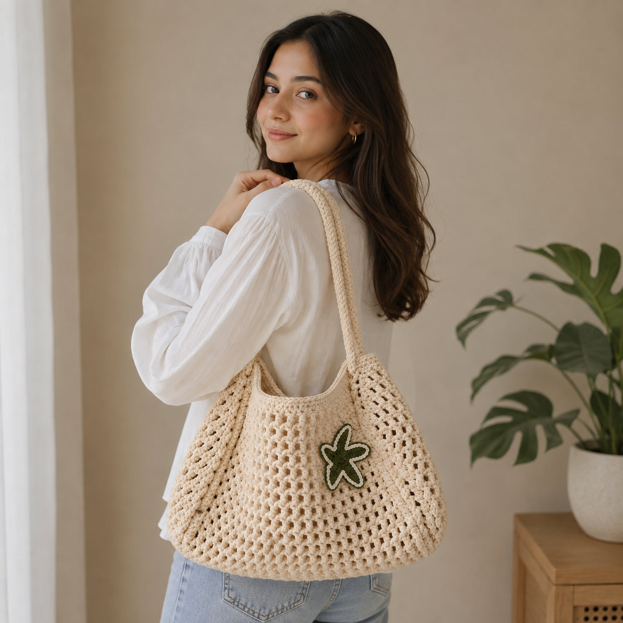 Side profile showing the depth and weave construction of the cream crochet tote bag.