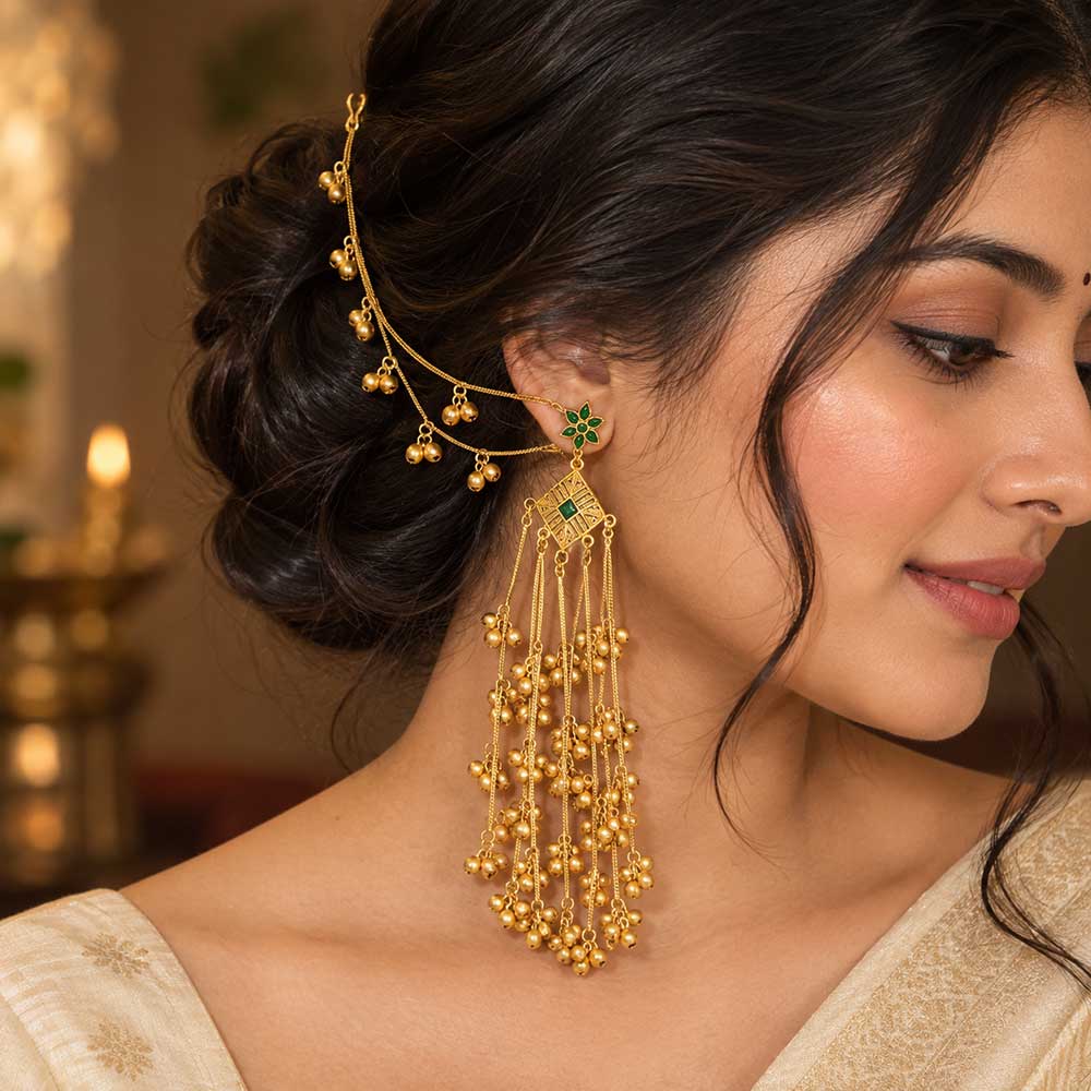Close-up detail of DI gold plated Bahubali earring showcasing green crystal floral cluster and fine textured gold craftsmanship
