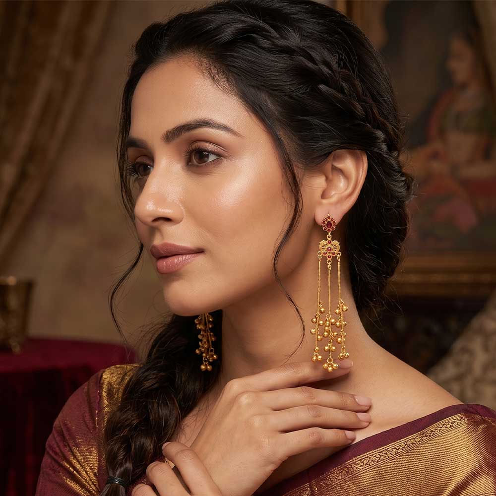 Close-up detail of the filigree work and ruby setting on the DI gold plated earrings
