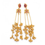 Front view of ornate DI gold plated Jhumka earrings with red ruby stones and dangling bell tassels