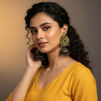 Woman wearing large, ornate earrings against a gradient background