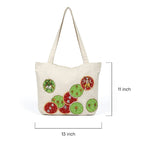 Beige tote bag with colorful circular designs on a white background
