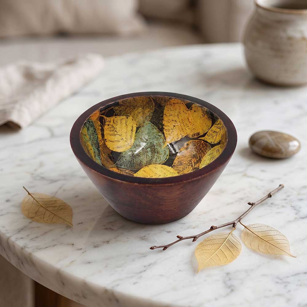 Enamel printed mango wood decorative bowl styled in a warm rustic dining setting