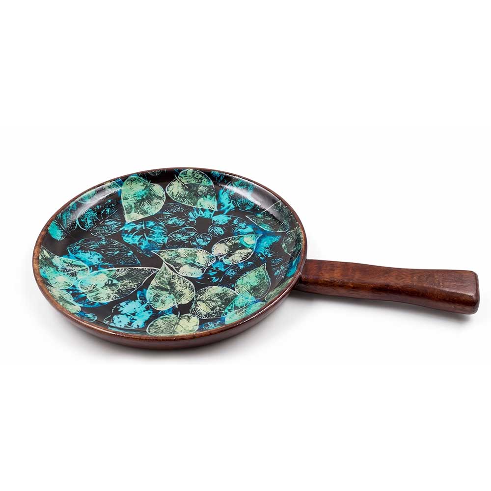 Close-up perspective of the enamel print detail on the mango wood serving tray, highlighting the intricate leaf texture and high-gloss finish.