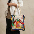 Handbag with intricate design and colorful patterns held by a person against a neutral background