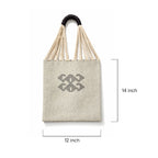 Beige tote bag with black handle and geometric design, shown with dimensions on a white background.