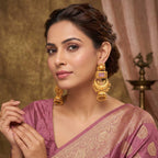Side angle of gold plated ethnic jhumka earrings showing intricate metalwork