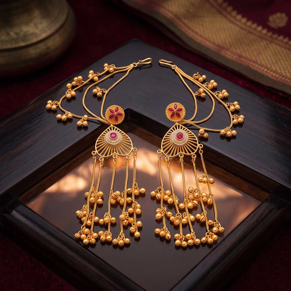 Angled view showcasing the drape of the gold jhumki chains on the traditional ear cuff jewelry.