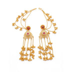 A pair of gold-plated traditional ear cuffs with ruby red stones and hanging jhumki beads, front view.