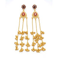 A pair of DI gold-plated traditional drop earrings with red stone centers and dangling ghungroo beads against a white background.