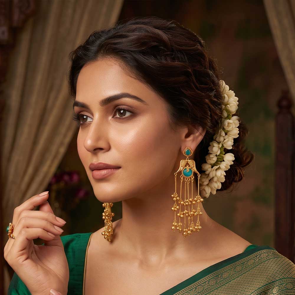 Side angle of traditional gold plated jhumka earrings showing intricate craftsmanship.
