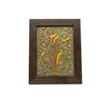 Front view of an artisan hand-carved stone relief painting depicting birds and a tree in a dark wooden frame.