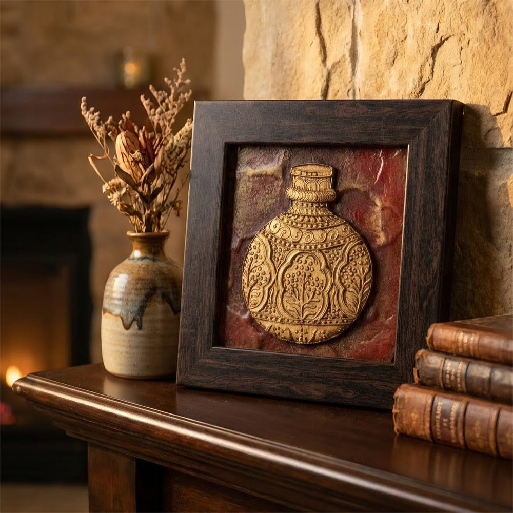 Detailed close-up of the embossed golden vase motif on the artisan stone painting.