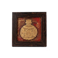 Artisan hand-carved stone painting of a golden vase in a dark wooden frame, front view.