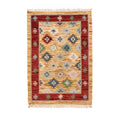 A hand-knotted Mirzapur wool area rug with a red border and multi-colored geometric tribal patterns, front view.