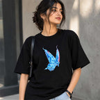 Close-up detail of the hand-painted vibrant blue butterfly artwork on pure black cotton fabric
