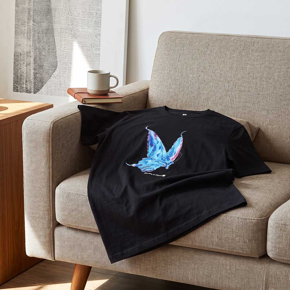 Angled perspective showing the pure cotton texture and fit of the hand-painted butterfly t-shirt